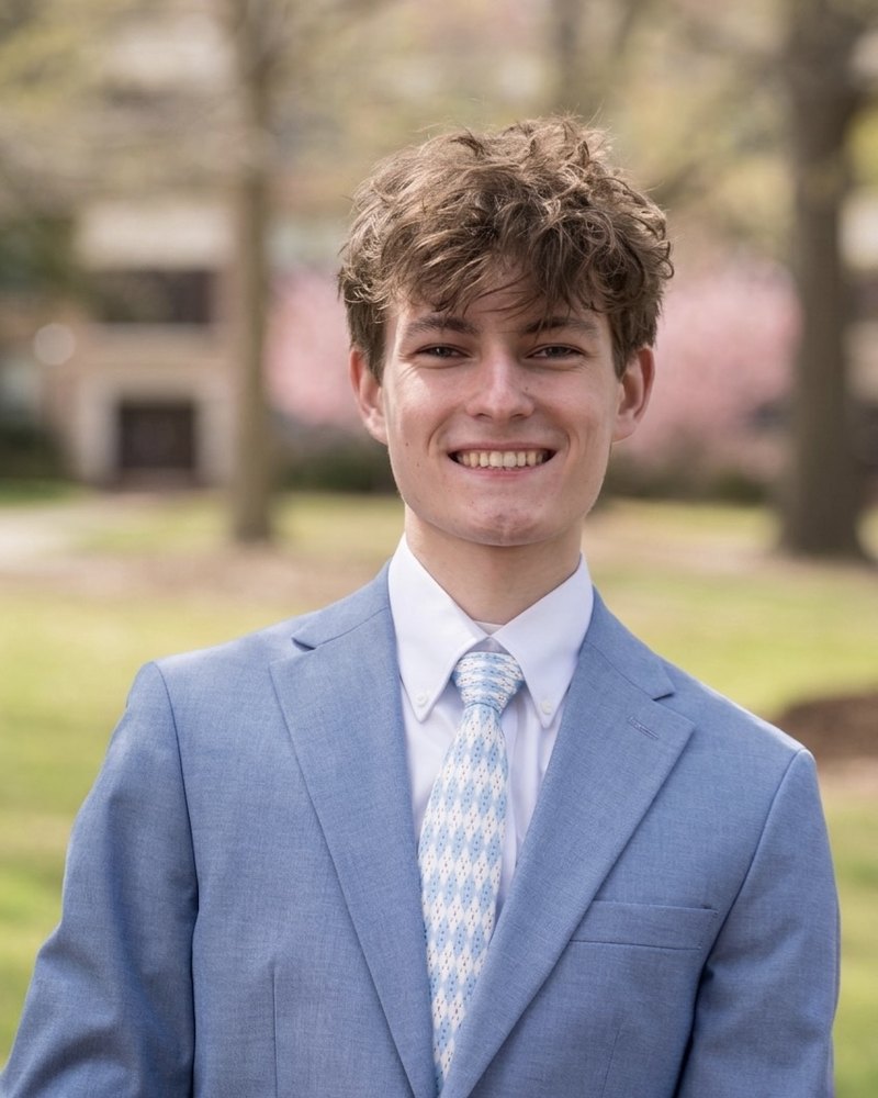 Brady Rickenbaugh, photographed outdoors on a college campus in spring.
